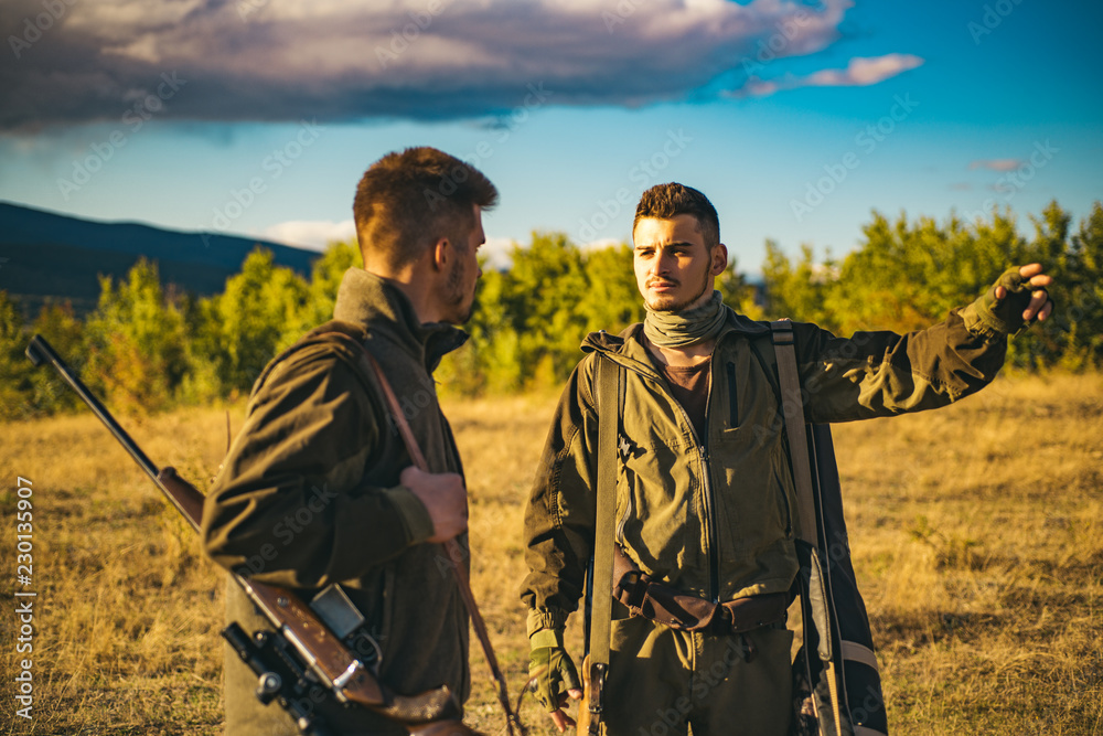 Two Hunters with shotgun gun on hunt. Group deer hunt. What Animals Can