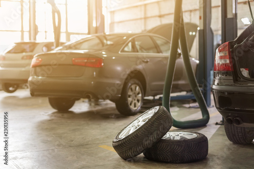 Car service center. Vehicle raised on lift at maintenance station. Auomobile repair and check up photo