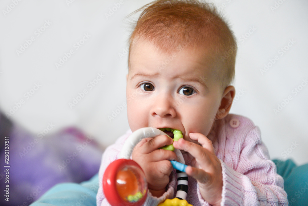 Cute baby girl plays with her chew toy for teeth Cute baby girl plays with her chew toy for teeth