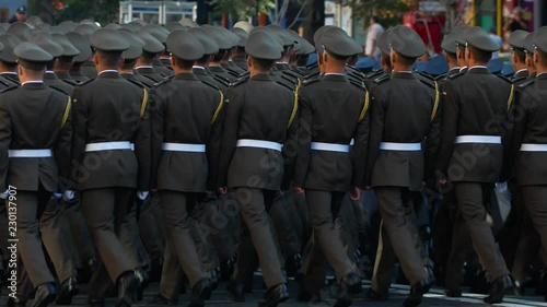 Ranks of soldiers marching at street