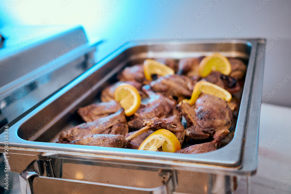 Catering table duck leg with lemon decoration at wedding party Catering table duck leg with lemon decoration at wedding party