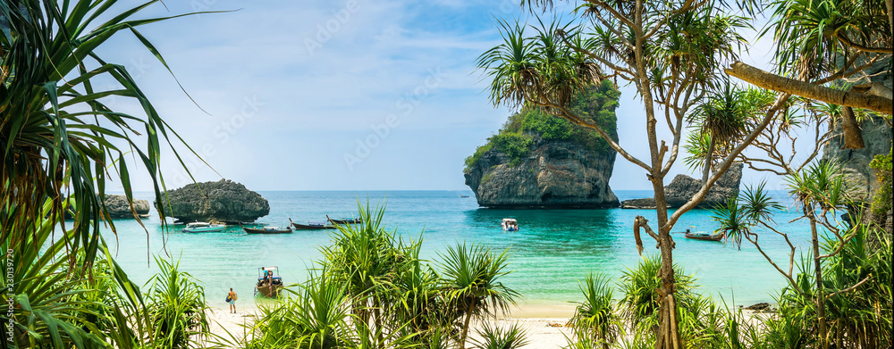Fototapeta premium Amazing view of beautiful beach on Phi Phi Island with longtale boat. Location: Krabi Province, Thailand, Andaman Sea. Artistic picture. Beauty world. Panorama