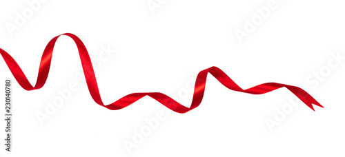 Delicate red wavy ribbon isolated on white background. New Year or Christmas holidays decoration concept.