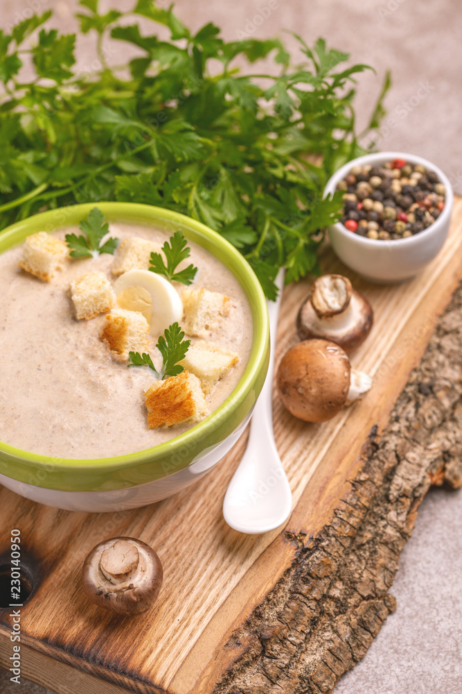 Tasty pureed mushroom soup in clay bowl with ingredients Tasty pureed mushroom soup in clay bowl with ingredients