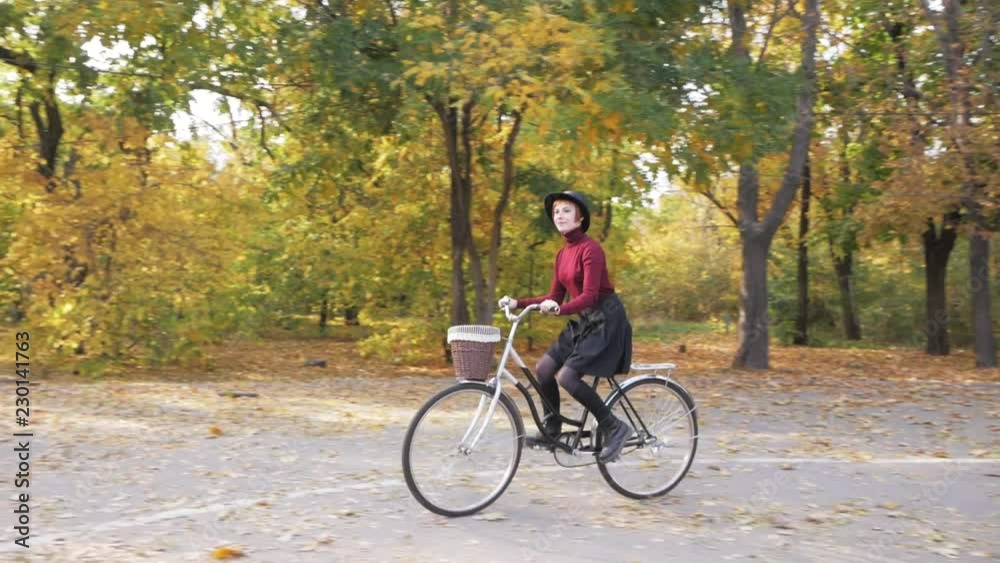 young woman riding on retro bicycle in the autumn park young woman riding on retro bicycle in the autumn park