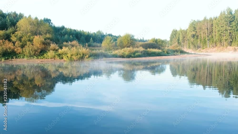 Mist over the river. Autumn beautiful landscape of forest is reflected in the water on the riverbank. Mist over the river. Autumn beautiful landscape of forest is reflected in the water on the riverbank.