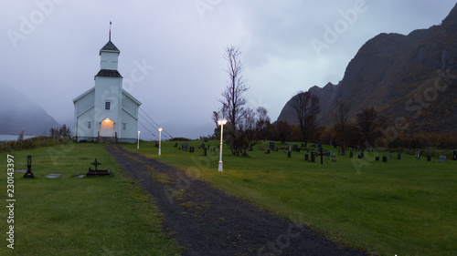 Gimsoy church lit up during dark autumn hours, Lofoten, Norway photo