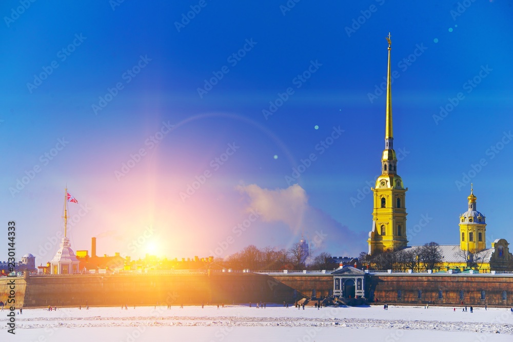 Fototapeta premium Art views of St. Petersburg. Picturesque winter landscape the Peter and Paul fortress in bright rays sun.