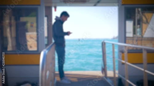 Blurred Siluettes people are waiting for vaporetto in Venice Italy