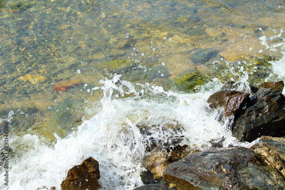 Transparent cold water on the lake and stones. Background. Landscape. Transparent cold water on the lake and stones. Background. Landscape.