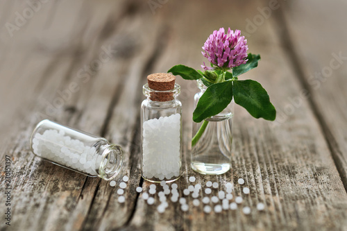 Homeopathic granules and small flowers. photo