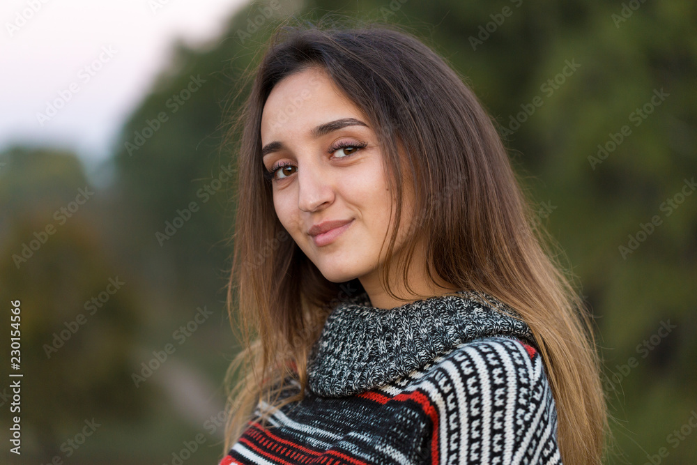Autumn portrait of a girl in ethnic sweater	