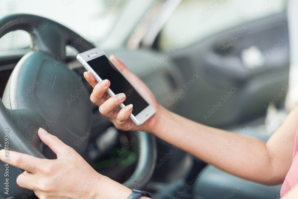 women driver with a cell phone