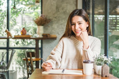 Free Download Asian woman working on labtop in coffee shop - GFXLoad