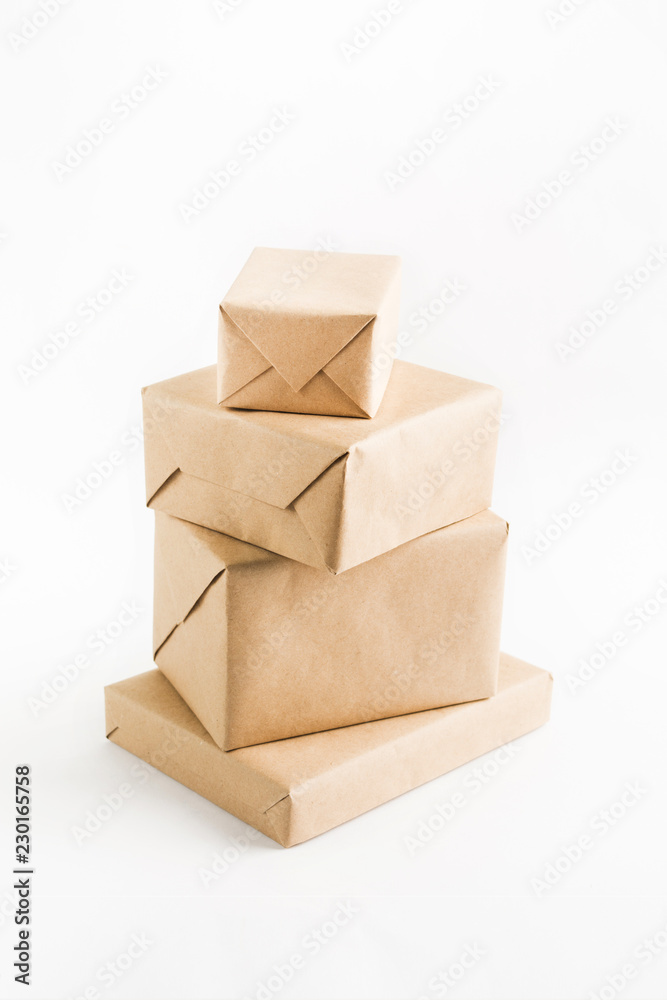 Obraz premium Stack of craft wrapped boxes for delivery