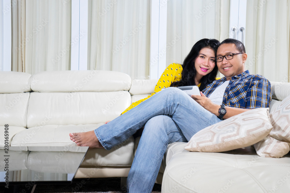 Asian couple using a tablet at home Asian couple using a tablet at home