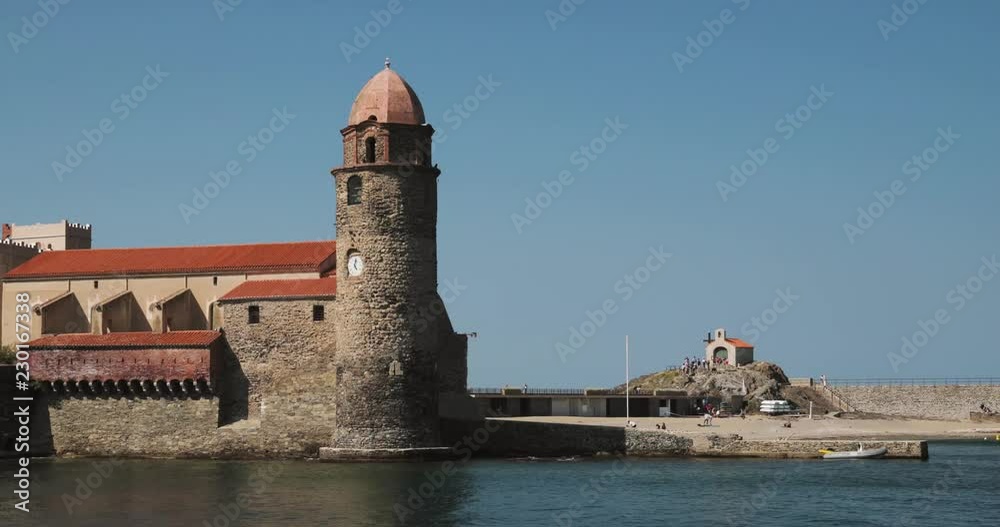 Collioure, France. Church Of Our Lady Of The Angels Across Bay In Sunny Day Collioure, France. Church Of Our Lady Of The Angels Across Bay In Sunny Day