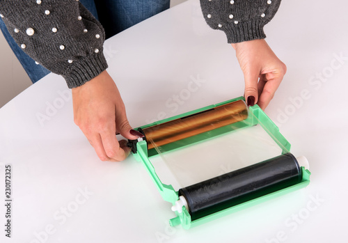 Woman adjusting the ribbon for a printer