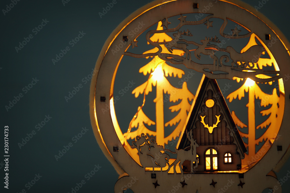Low key Image of magical christmas scene of wooden pine forest, hut and santa claus over sleigh with deers. Low key Image of magical christmas scene of wooden pine forest, hut and santa claus over sleigh with deers.