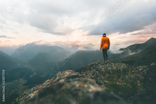 Man adventurer on mountain summit hiking Traveling alone heathy lifestyle active vacations trail running outdoor photo