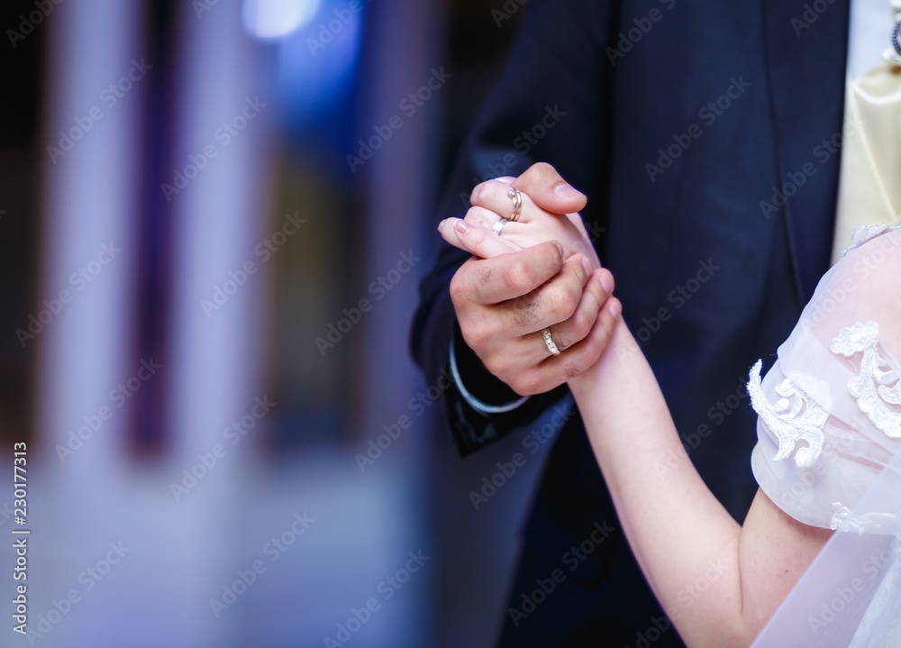 groom and bride holding hands