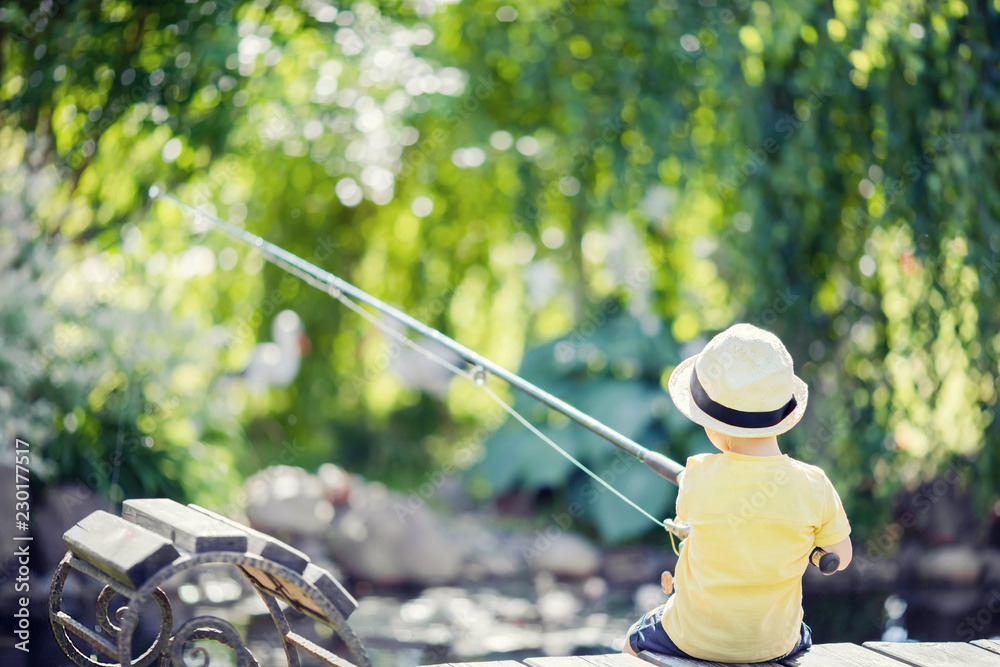 Toddler boy fishing in the lake