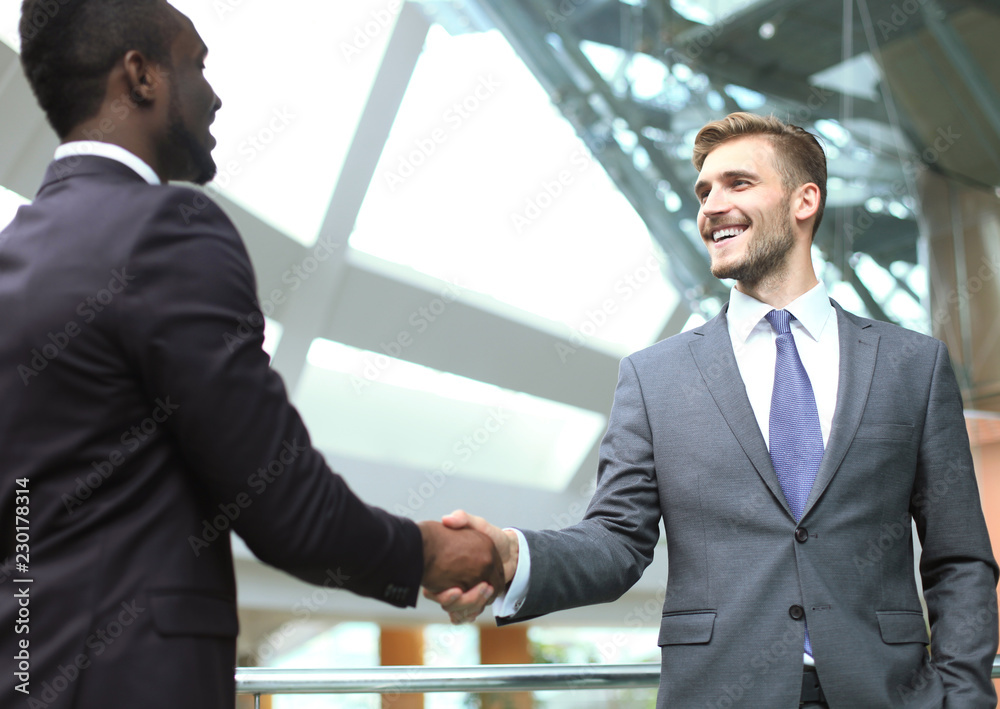 Business meeting. African American businessman shaking hands with caucasian businessman. Business meeting. African American businessman shaking hands with caucasian businessman.