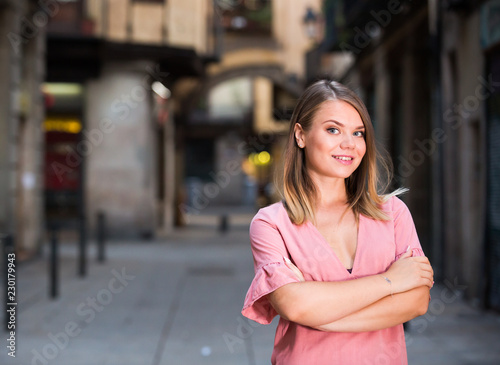 Young positive female standing in the historical center of Barcelona © JackF