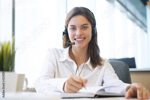 Customer support operator working in a call center office. photo