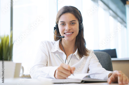 Customer support operator working in a call center office.