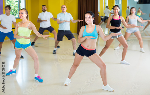 Young group of people are learning zumba movements