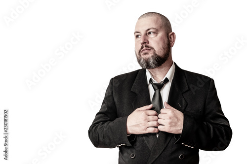 The man of the successful type in a jacket with a tie and a beard.