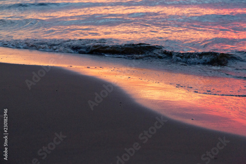 Purple orange sunset Baltic Sea and surf in autumn