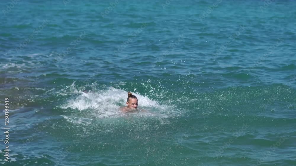 Cheerful young girl having fun in the sea Cheerful young girl having fun in the sea