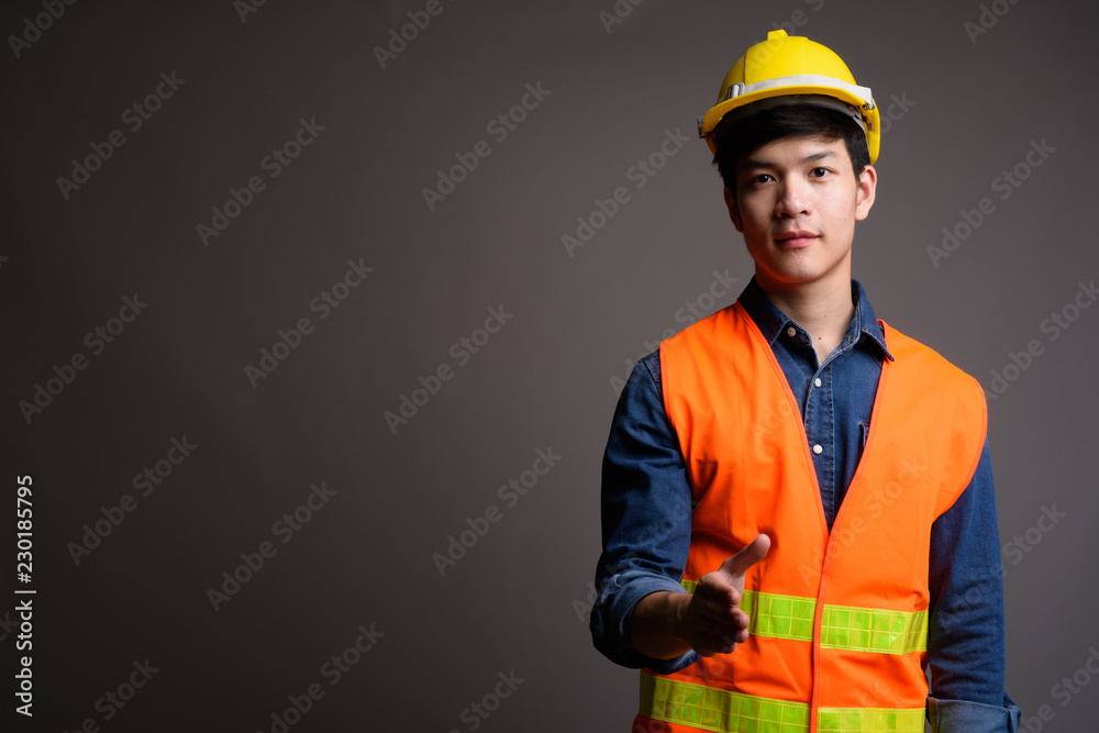 Asian man construction worker giving handshake for agreement Asian man construction worker giving handshake for agreement