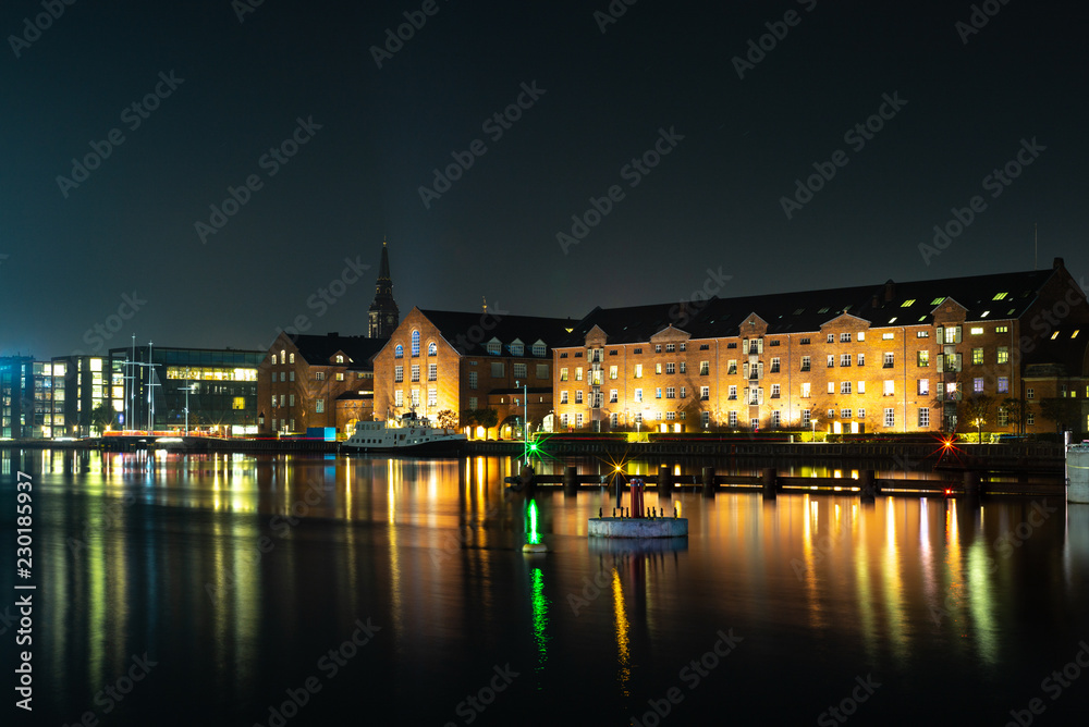 Waterside buildings in Copenhangen during a colorful sunset reflecting in the water channel - 2
