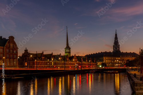 View of the Borsen (Danish for exchange) building in Copenhangen at night reflecting in the water channel - 1