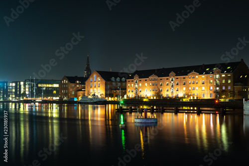 Waterside buildings in Copenhangen during a colorful sunset reflecting in the water channel - 2 © gdefilip