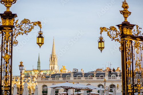 Cityscape view on the central square with beautiful Golden gates and cathedral tower in Nancy, France photo