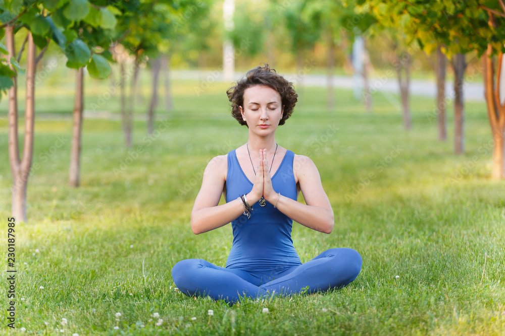 Yoga instructor in lotus position and meditating Yoga instructor in lotus position and meditating