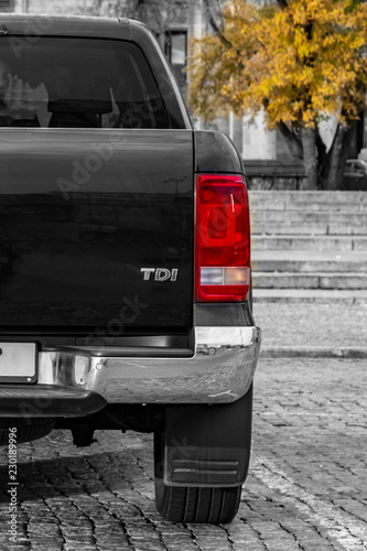 large SUV rear view. against a backdrop of granite steps and wood