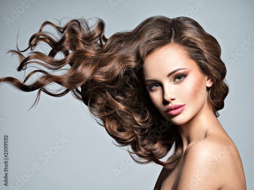 Face of a beautiful  woman with long flying   hair