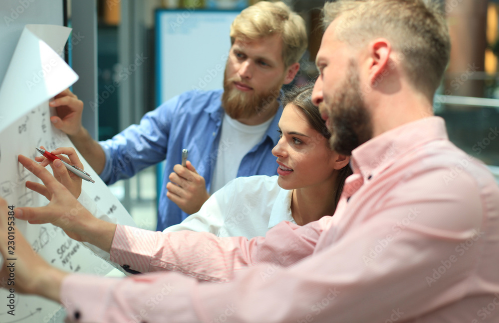 Group of young business people and designers in smart casual wear. They working on new project. Group of young business people and designers in smart casual wear. They working on new project.