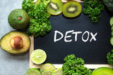 DETOX chalk inscription on the board table.  Diet for the healthy body and detox with fresh green fruits  and vegetable.  Healthy Concept.