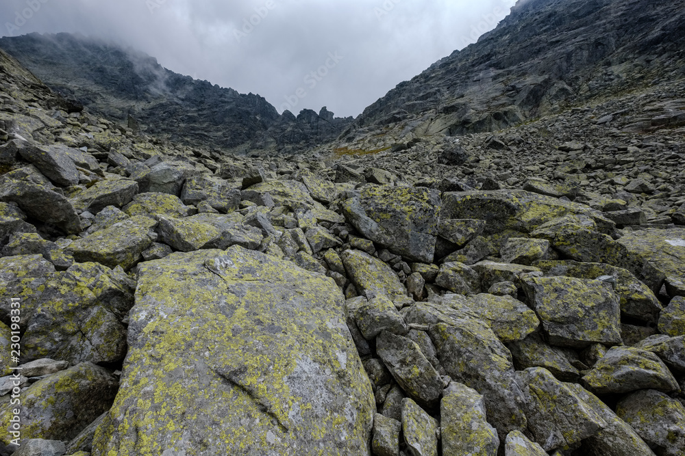 peak of Rysy mountain covered in mist. autumn ascent on hiking trails peak of Rysy mountain covered in mist. autumn ascent on hiking trails