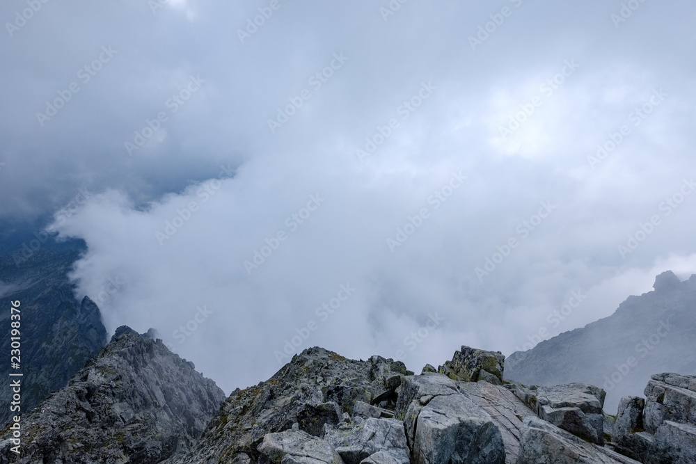 peak of Rysy mountain covered in mist. autumn ascent on hiking trails peak of Rysy mountain covered in mist. autumn ascent on hiking trails