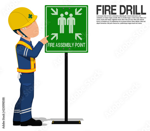 A worker is presenting the fire assembly point sign