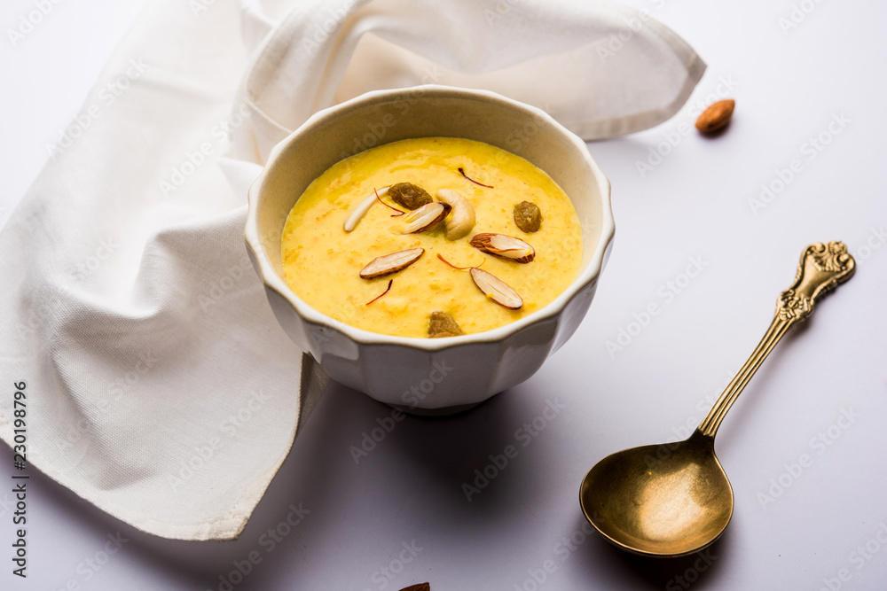 Kaddu or Pumpkin Kheer Or Bhoplyachi Kheer in Marathi and gummadikaya payasam in Telugu, Garnished with dry fruits. served in a bowl over moody background. Selective focus Kaddu or Pumpkin Kheer Or Bhoplyachi Kheer in Marathi and gummadikaya payasam in Telugu, Garnished with dry fruits. served in a bowl over moody background. Selective focus