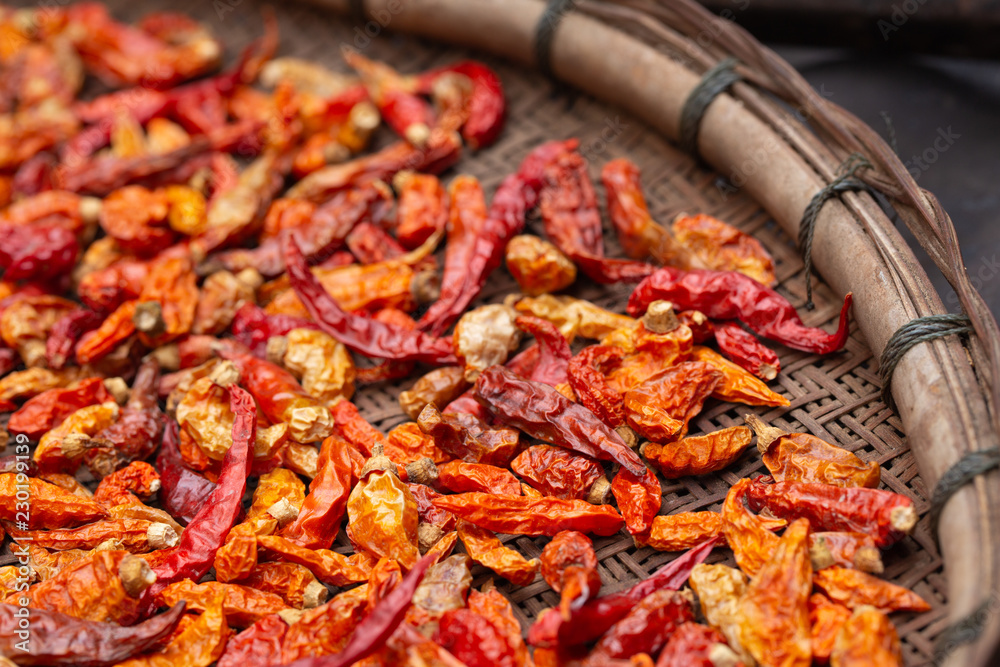 Dried red and yellow chilli on threshing basket Dried red and yellow chilli on threshing basket