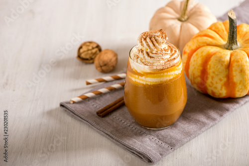 Fototapeta Naklejka Na Ścianę i Meble -  Pumpkin spice latte, hot coffee drink with pumpkins, whipped cream and spices